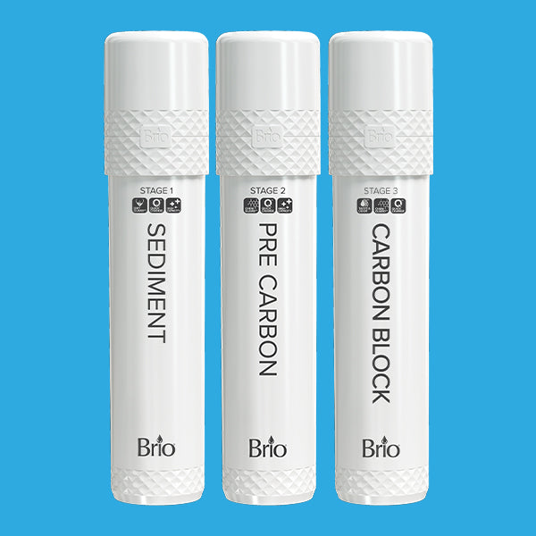 Three white cylindrical water filter cartridges labeled Sediment, Pre Carbon, and Carbon Block arranged upright against a solid blue background. Each is marked with its stage number and the brand name Brio.